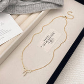 MICRO PAVED ZIRCONIA PEARL BOW PENDANT NECKLACE_CWAJE3059