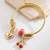 GOLD BEADED BRACELET WITH CRYSTAL CHARMS_CWMM8495