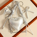 ELEGANT SILVER HEART BOW BAG KEYCHAIN_CWMM7640