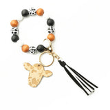 COW HEAD KEYCHAIN WITH TASSEL AND WOOD BEADS_CWAB5093