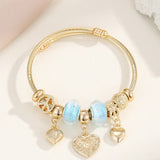 GOLD STEEL BRACELET WITH BEAR HEART CHARMS_CWMM8485