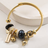 GOLD STAINLESS STEEL BRACELET WITH ANIMAL CHARMS_CWMM8574