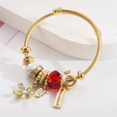 GOLD STAINLESS STEEL BRACELET WITH FLOWER PENDANT_CWMM8587