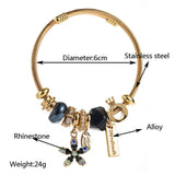 GOLD STAINLESS STEEL BRACELET WITH FLOWER PENDANT_CWMM8587