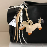 CUTE LEATHER DACHSHUND BAG CHARM WITH SHUTTLECOCK_CWMM7565