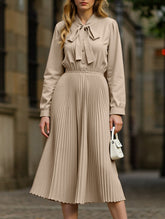 Elegant pleated dress with bow tie collar