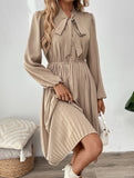 Elegant pleated dress with bow tie collar