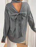 A striped printed long-sleeved shirt with a bow
