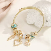 GOLD STEEL BRACELET WITH BEAR HEART CHARMS_CWMM8485