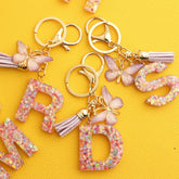 PINK SNOWFLAKE LETTER BUTTERFLY KEYCHAIN_CWMM6865