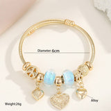 GOLD STEEL BRACELET WITH BEAR HEART CHARMS_CWMM8485