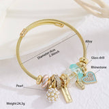 GOLD BRACELET WITH TREE HEART TAIL CHARMS_CWMM8620