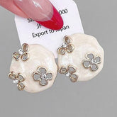 HOLLOW ZIRCON GEOMETRIC FLOWER EARRINGS_CWAJE2040