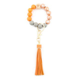 PRINTED WOOD BEAD BRACELET KEYCHAIN WITH TASSEL_CWMM7025
