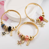 GOLD STAINLESS STEEL BRACELET WITH FLOWER PENDANT_CWMM8587