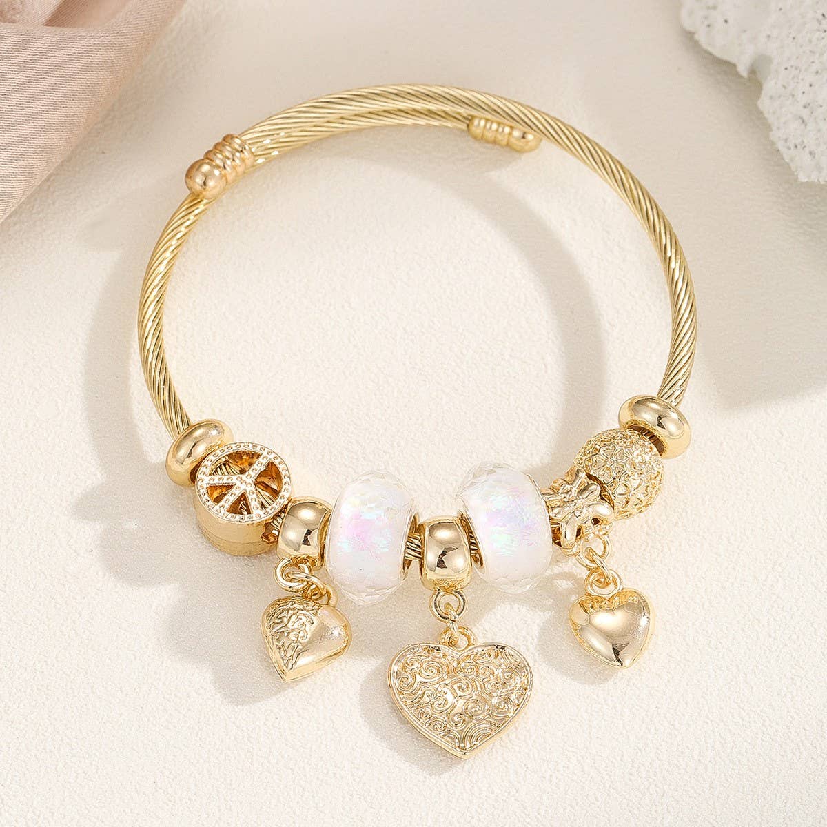 GOLD STEEL BRACELET WITH BEAR HEART CHARMS_CWMM8485