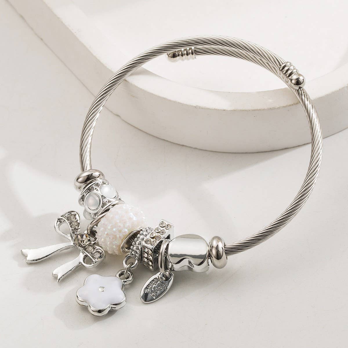 SILVER STEEL BRACELET WITH BOW FLOWER CHARMS_CWMM8613