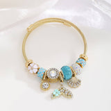 GOLD BRACELET WITH TREE HEART TAIL CHARMS_CWMM8620