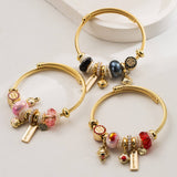 GOLD STAINLESS STEEL BRACELET WITH ANIMAL CHARMS_CWMM8574