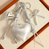 ELEGANT SILVER HEART BOW BAG KEYCHAIN_CWMM7640