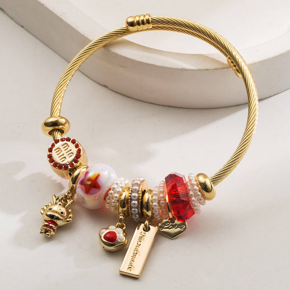 GOLD STAINLESS STEEL BRACELET WITH ANIMAL CHARMS_CWMM8574