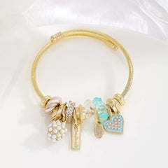 GOLD BRACELET WITH TREE HEART TAIL CHARMS_CWMM8620