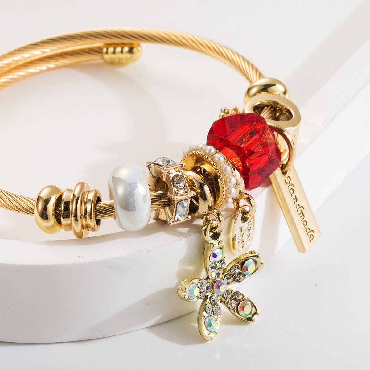 GOLD STAINLESS STEEL BRACELET WITH FLOWER PENDANT_CWMM8587