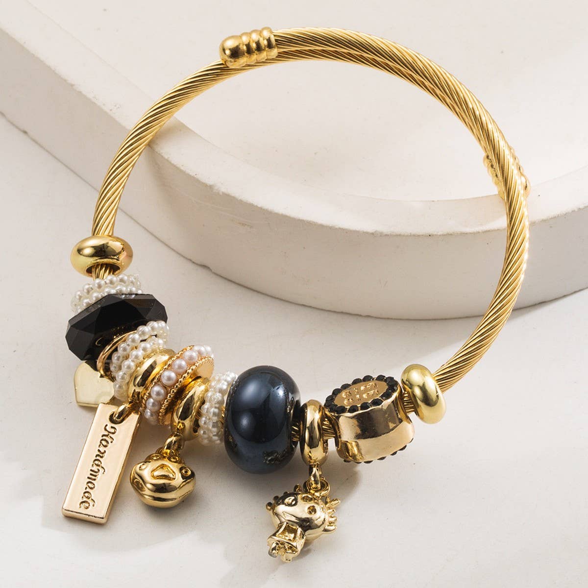 GOLD STAINLESS STEEL BRACELET WITH ANIMAL CHARMS_CWMM8574