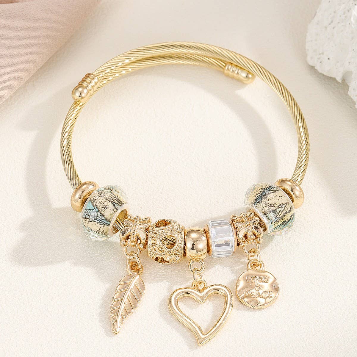 GOLD STEEL BRACELET WITH BEAR HEART CHARMS_CWMM8485