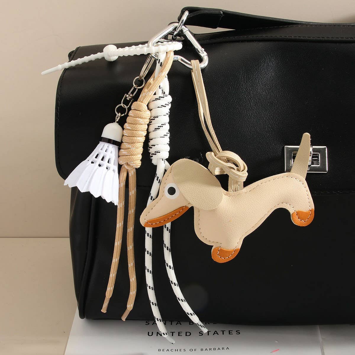 CUTE LEATHER DACHSHUND BAG CHARM WITH SHUTTLECOCK_CWMM7565