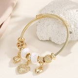 GOLD STEEL BRACELET WITH BEAR HEART CHARMS_CWMM8485