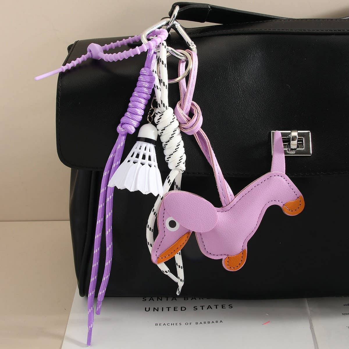 CUTE LEATHER DACHSHUND BAG CHARM WITH SHUTTLECOCK_CWMM7565