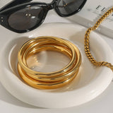 ELEGANT GOLD TONE ROUND BANGLE TITANIUM STEEL_CWAJE4704