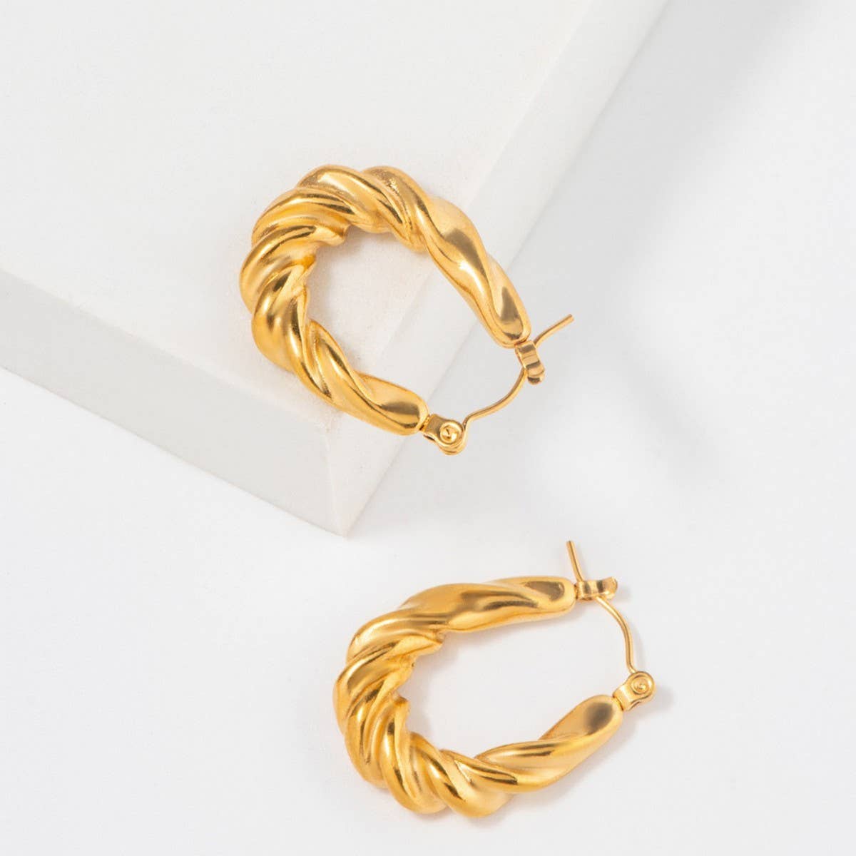 GOLD STAINLESS STEEL TWISTED U SHAPED EARRINGS_CWMM3652